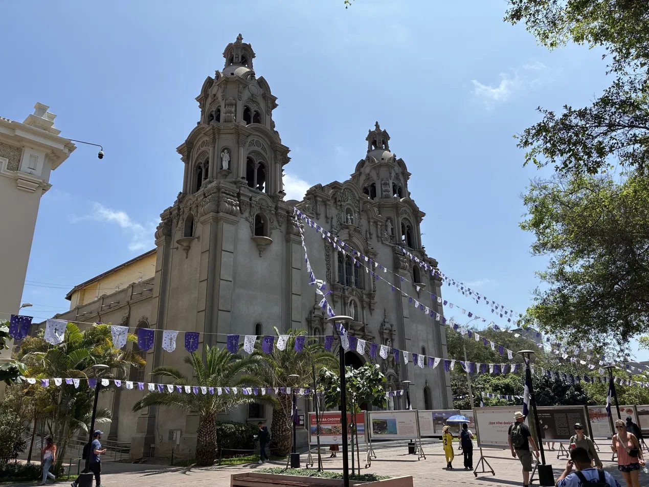 Church façade on the plaza, bunting strung across the square