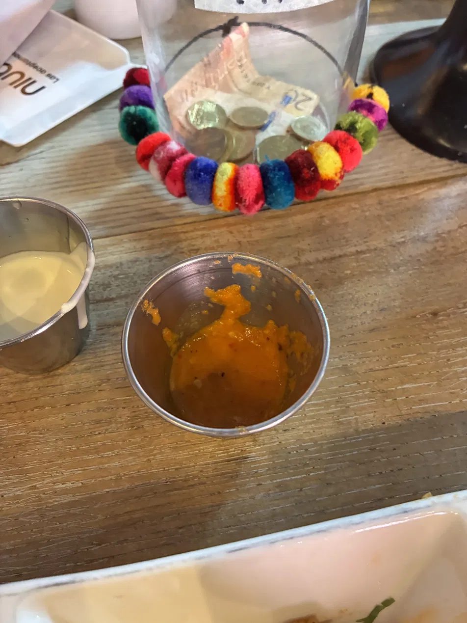 Two dipping sauces on a wooden table