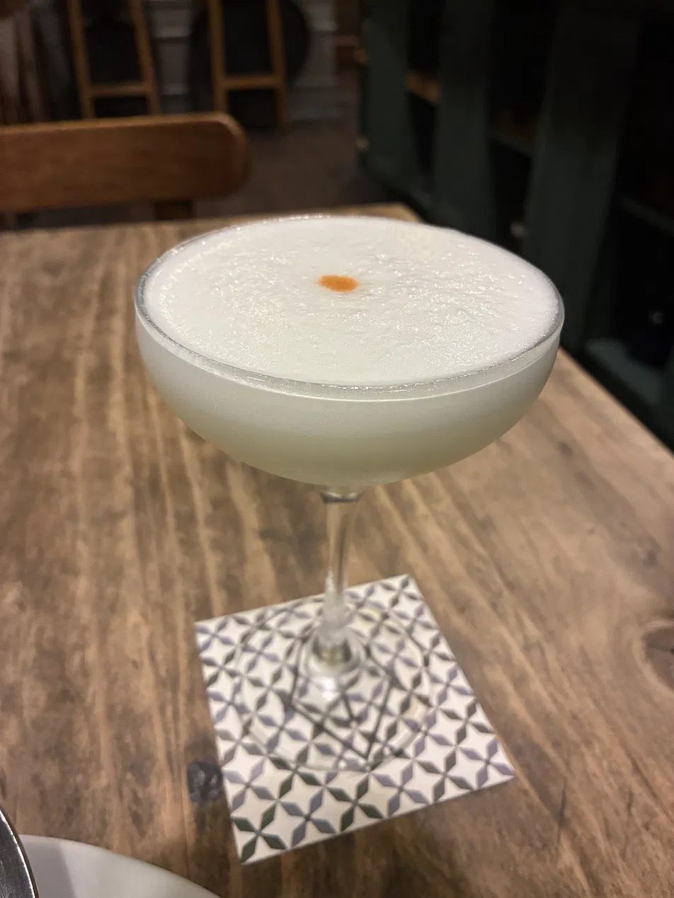 A pisco sour with its bitters dot